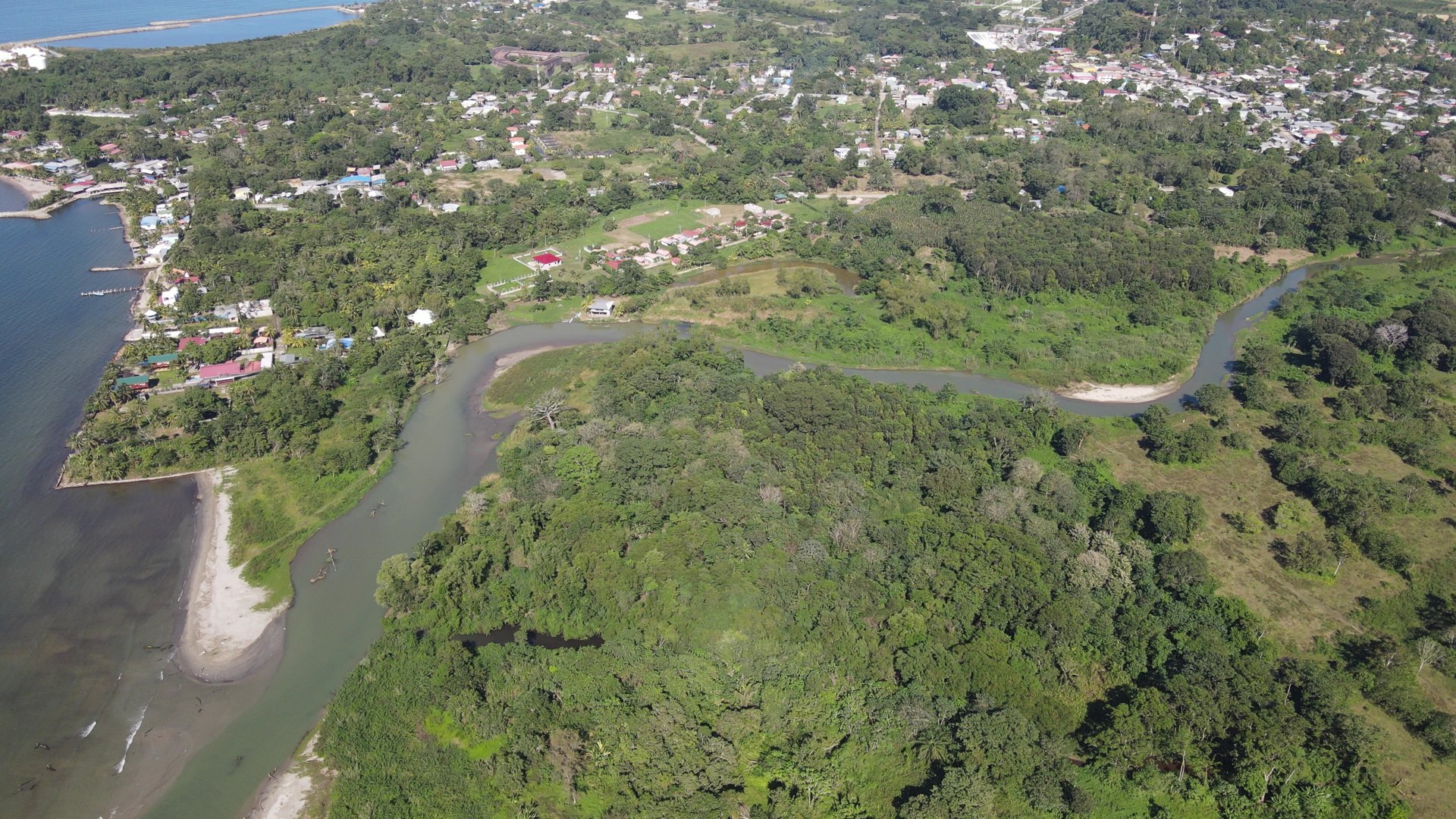 Drone photo of the river mouth, the beach and the town of Omoa next to the land